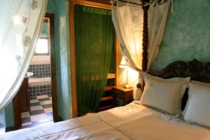 Caspueñas克普利由郊区艾尔玛兰艾尔酒店的一间卧室配有天蓬床和镜子