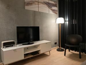 聚滕达尔Shelter的一间客厅,客厅内配有一台电视,位于白色娱乐中心