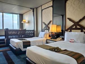 清迈Chiang Mai Orchid Hotel SHA EXTRA PLUS的酒店客房设有两张床和窗户。