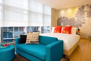 香港港岛英迪格酒店的一间卧室配有一张床和一张蓝色椅子