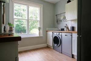 刘易斯Contemporary 2 Bedroom Flat in Lewes的厨房配有洗衣机和窗户。