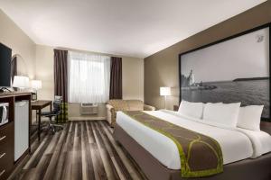 萨尼亚超级8萨尼亚酒店的酒店客房设有一张大床和一张书桌。
