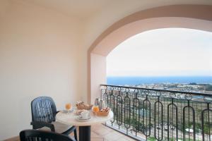 拉克鲁斯Hotel Las Águilas Tenerife, Affiliated by Meliá的阳台配有桌椅,享有海景。