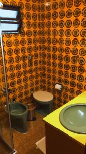 格拉玛多Casa Goldoni Gramado的浴室设有2个卫生间和绿色水槽