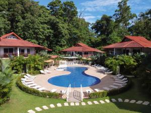 别霍港Terrazas del Caribe Aparthotel的一个带游泳池、椅子和树木的度假酒店