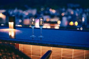 京都Sora Niwa Terrace Kyoto的三杯酒,坐在一顶酒柜上