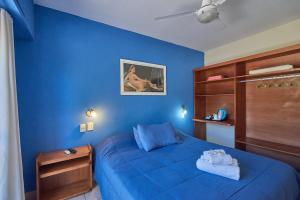 维多利亚El Molino - Complejo Turístisco的蓝色的卧室,配有床和蓝色的墙壁