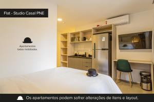 圣保罗Charlie Sabiá Ibirapuera的小房间设有一张床和一台冰箱