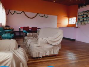 ChimborazoHospedaje Chimborazo的一间设有一排白色床单的床的房间