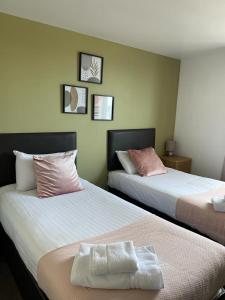 弗雷泽堡达夫隆酒店的两张睡床彼此相邻,位于一个房间里