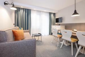 奥伯古格尔维尔沃公寓式酒店的客厅配有沙发和桌椅