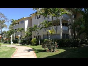 博卡奇卡Room in Apartment - Delightful Caribbean apartment in Boca Chica的一座大型公寓楼,拥有棕榈树和人行道