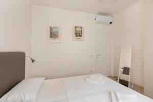 斯特雷萨Felix 10的白色的卧室配有白色的床和镜子