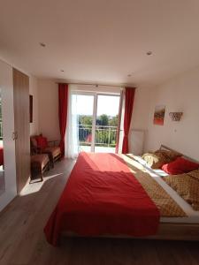 伦格里希Ferienwohnung zum Wohlfühlen的一间卧室配有一张带红色毯子的大床