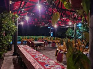 Tanjung KarangAsiaCamp - Cabin Sungai Sireh的一组桌椅,位于一间灯光的房间