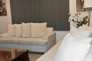 奥克兰The Rise BNB - Executive Ensuite的带沙发和白色枕头的客厅