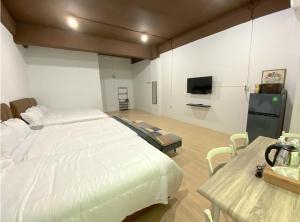 名古屋CN Homestay C1 Floor 3 at Nagoya Hill Mall的卧室配有一张白色大床和电视。