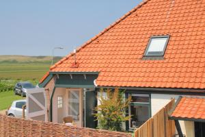 卡兰茨奥赫de Dars的一座房子,屋顶橙色,前面有停车位