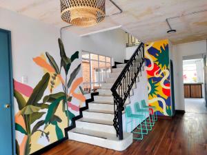 波哥大Trip Monkey Chapinero的走廊上设有墙上壁画的楼梯