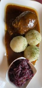 德罗尔斯哈根Buddes Wirtshaus的盘子,有肉,土豆,酱汁