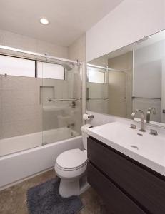 卡拉巴萨斯Private room in beautiful modern Calabasas townhouse的浴室配有卫生间、浴缸和水槽。