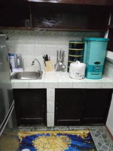 马尼拉Balili Property at Metro Manila Hills Subd Rodriguez Rizal的厨房柜台配有水槽和餐具