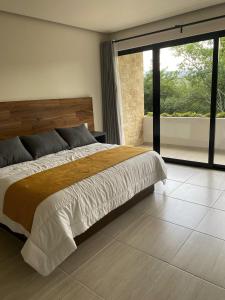 加尔潘Kali Secreto的一间卧室设有一张大床和一个大窗户