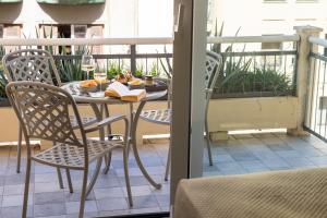 巴勒莫La Musa Apartments & Rooms的阳台上配有桌椅和书籍