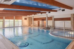 扎莫希奇阿蒂斯Spa酒店的蓝色海水大型室内游泳池