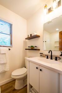 The Wren Treehouse 15 MIN to Magnolia Baylor的白色的浴室设有卫生间和水槽。
