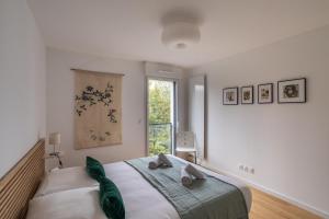 南特Le Bienveillant - T3 proche Jardin des Plantes的一间卧室设有一张大床和窗户