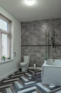 乔利Contractors accommodation in Chorley by Lancashire Holiday Lets的浴室配有卫生间、盥洗盆和浴缸。