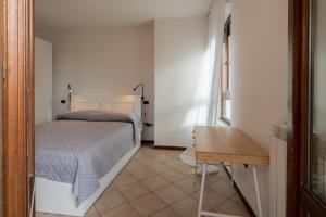 福利尼奥MIZAR- Appartamento privato con parcheggio gratuito by Appartamenti Petrucci的一间卧室配有一张床和一张木桌