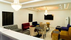 莱基247 Luxury Hotel & Apartment Ajah的一间设有五颜六色椅子和桌子的等候室