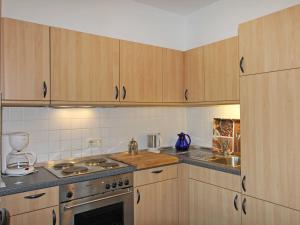 奥斯赛拜-塞林Villa Freya - Apt. 04的厨房配有木制橱柜和炉灶烤箱。