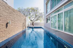 华欣Luxury Pool Villa at Golden Sea Hua Hin的一座砖墙房子中的游泳池