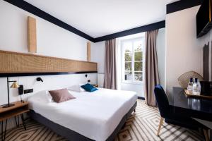 拉弗洛特乐法兰开斯酒店的酒店客房设有一张大床和一张书桌。