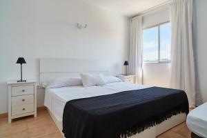 圣安东尼奥湾圣安东尼奥海滩公寓的白色的卧室设有一张大床和一个窗户