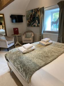 贝克韦尔布罗斯特菲尔德农场 - 布罗斯特菲尔度假屋的一间卧室配有一张床,上面有两条毛巾