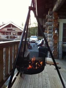 基尔匹斯扎我维Kelo Aurora luxury cabin的甲板上的火坑,带烤架