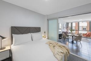 布里斯班Meriton Suites Adelaide Street, Brisbane的一间卧室设有一张床和一间客厅。