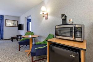 奥罗拉丹佛机场休闲公园品质套房酒店的酒店客房配备了微波炉和桌椅。