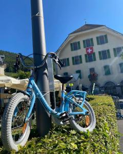 OllonHôtel de Ville d'Ollon的蓝色的自行车被锁在一根杆上
