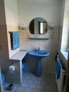 阿尔特瑙Haus Bindseil - Ferienwohnung im EG, rechts的浴室设有蓝色水槽和镜子