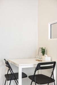 Ban Phraek SaPVILLA的客房内的一张带两把椅子的白色书桌