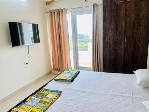瓦拉纳西Tranquil (Near Ghats and Temple)的卧室配有一张床铺,墙上配有电视