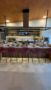 格拉玛多Vila Nambu - Exclusive Pousada的厨房配有长台面、椅子和食物