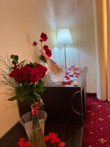 布拉索夫Top Royal Central Brasov的一张桌子,上面放着酒杯和鲜花