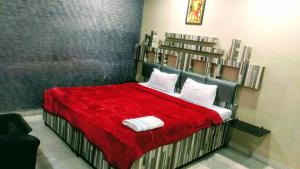 RourkelaTHE PRESTIGE HOTEL & CONVENTION的一间卧室配有红色床单和白色枕头。