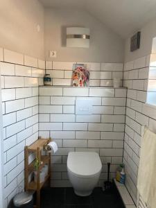 费马恩Casa Bianca的一间带卫生间和白色瓷砖墙壁的浴室